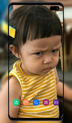 Funny Wallpaper app showing grumpy toddler expression as humorous mobile phone home screen background