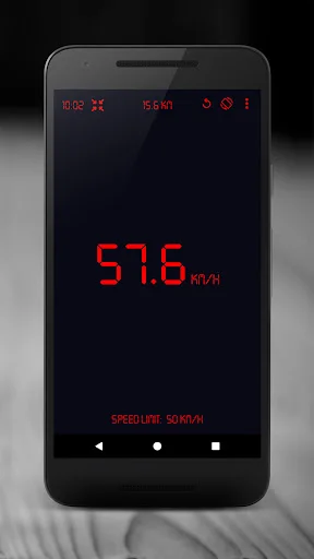 GPS Speedometer displaying 57.6 km/h in red digital numbers with speed limit warning on dark interface