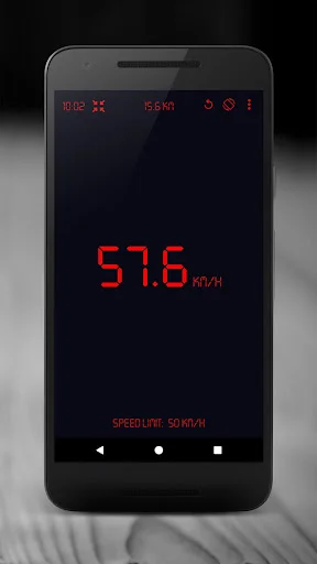 GPS Speedometer displaying 57.6 km/h in red digital numbers with speed limit warning on dark interface